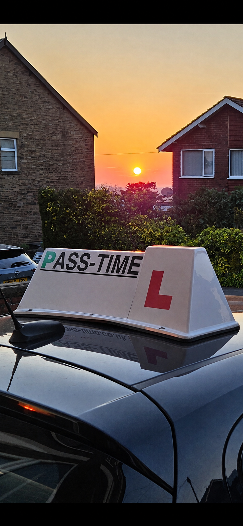 Pass-Time learner car roof sign in Marple at sunset